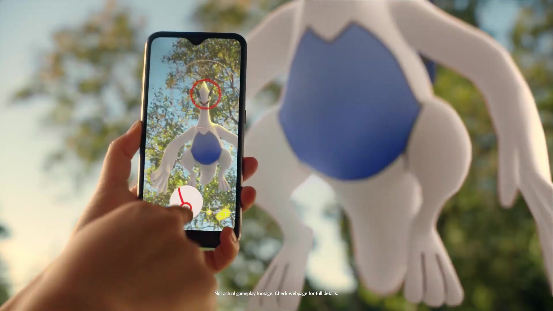A trainer encounters Lugia through her phone screen
